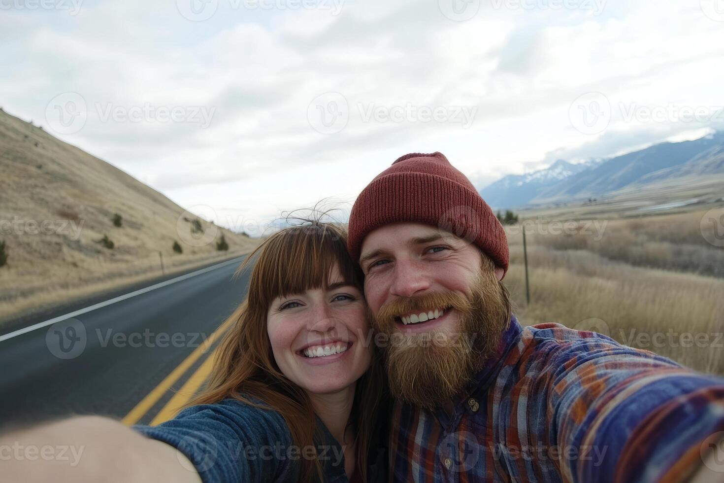 A man and woman taking a selfie on the road photo