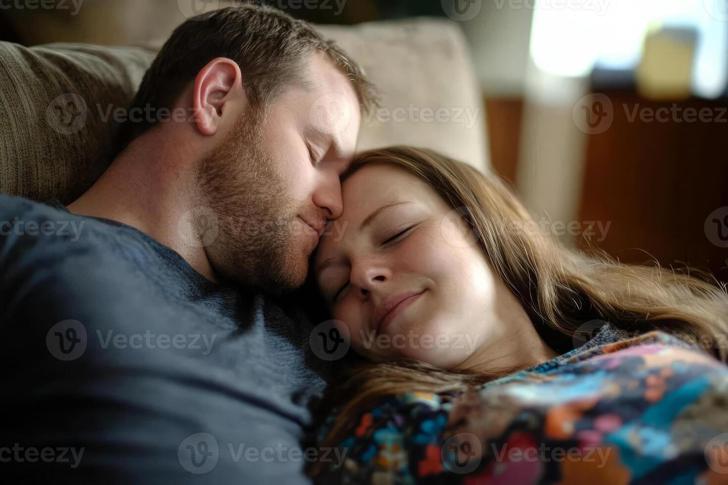 A man and woman are laying on a couch photo