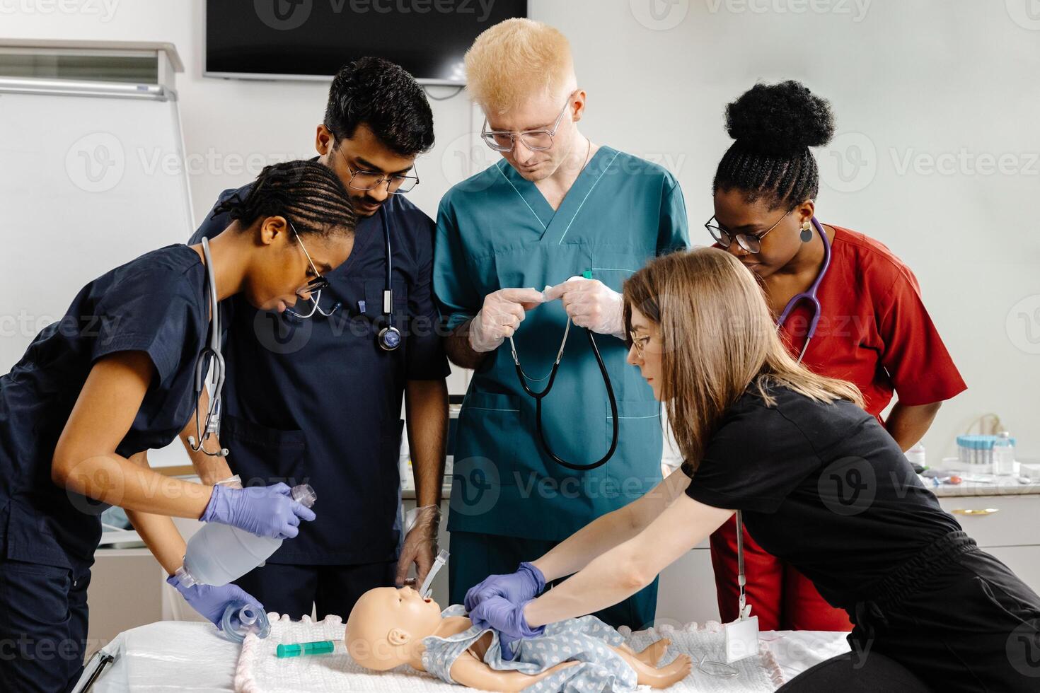 Medical Students Practicing Intubation Technique on Baby Mannequin during Training. photo
