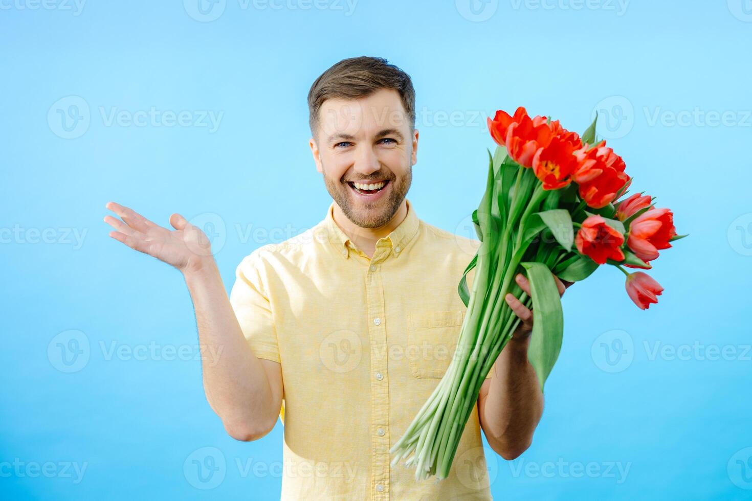 Man holding bunch of red flowers photo