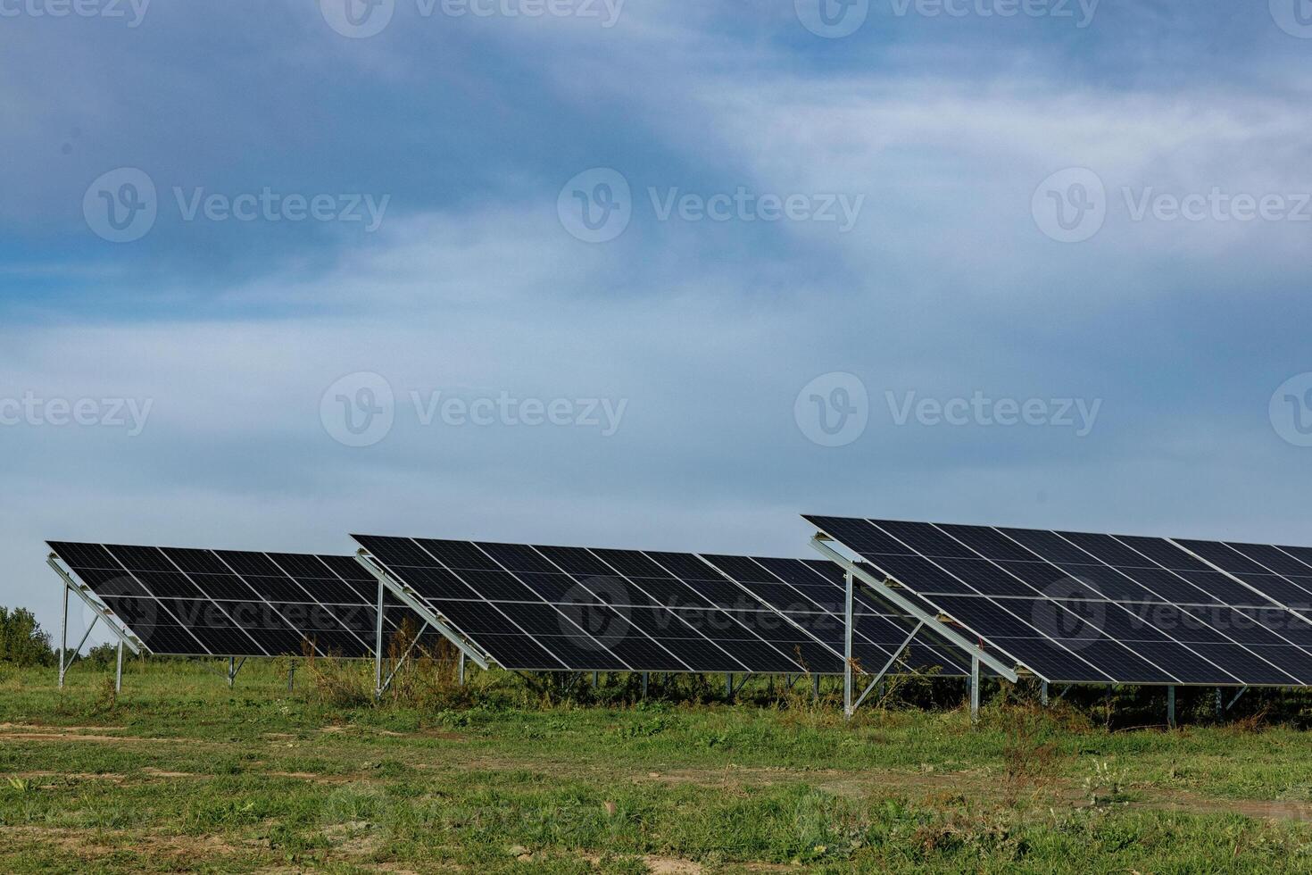 Solar panels providing renewable energy under a cloudy sky photo