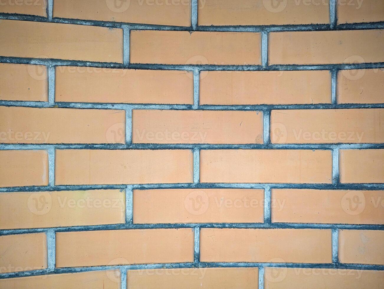 Close-up of a yellow facing brick wall with a textured surface photo