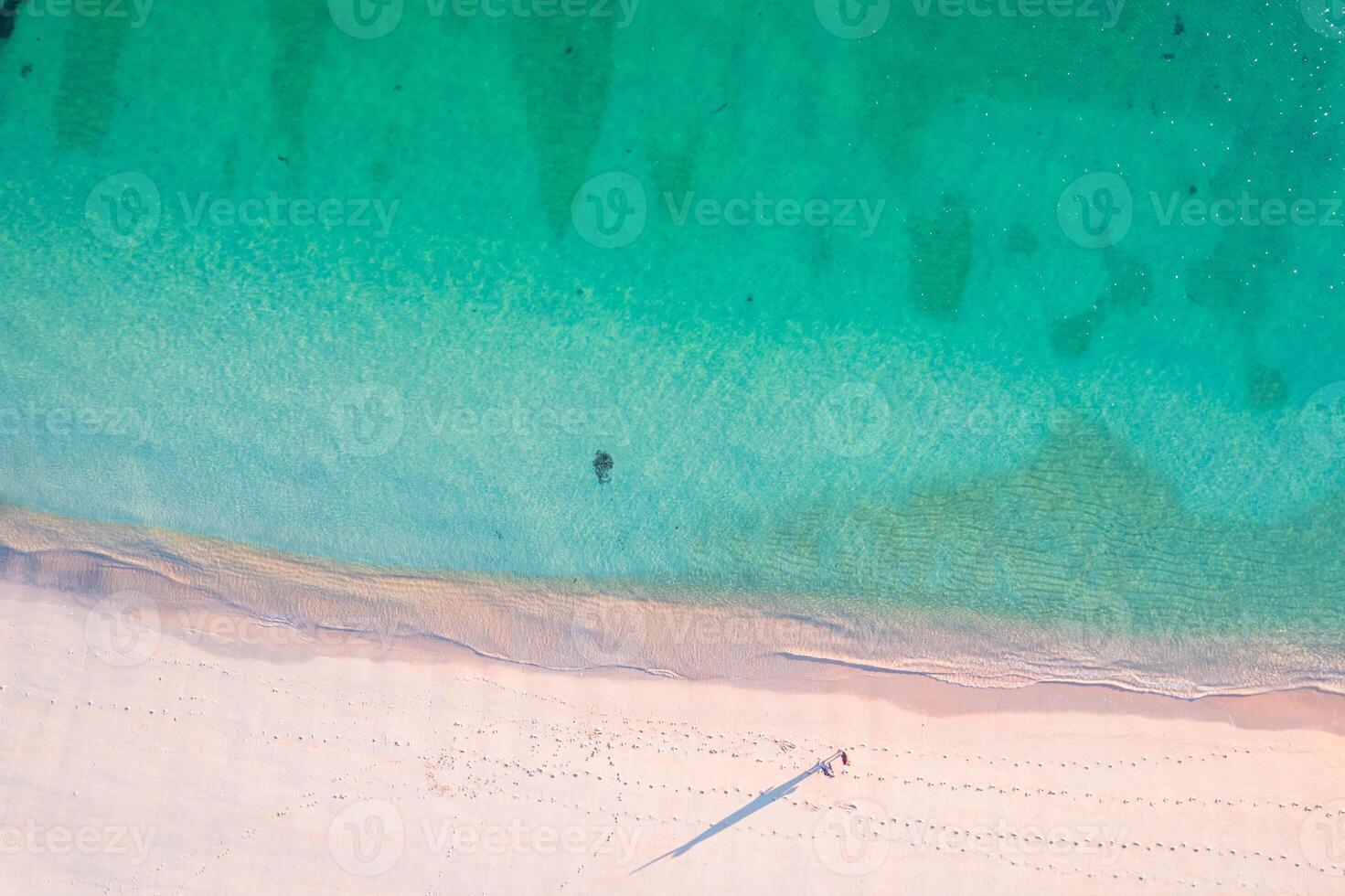 serene beach landscape with gentle waves and soft sand, overhead photography by drone photo