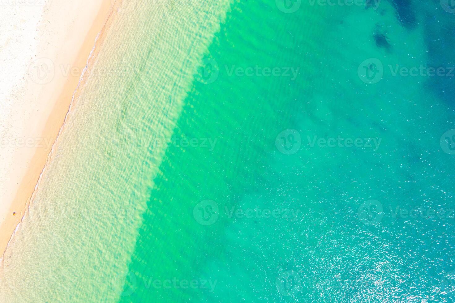 serene beach landscape with gentle waves and soft sand, top down view photography by drone photo