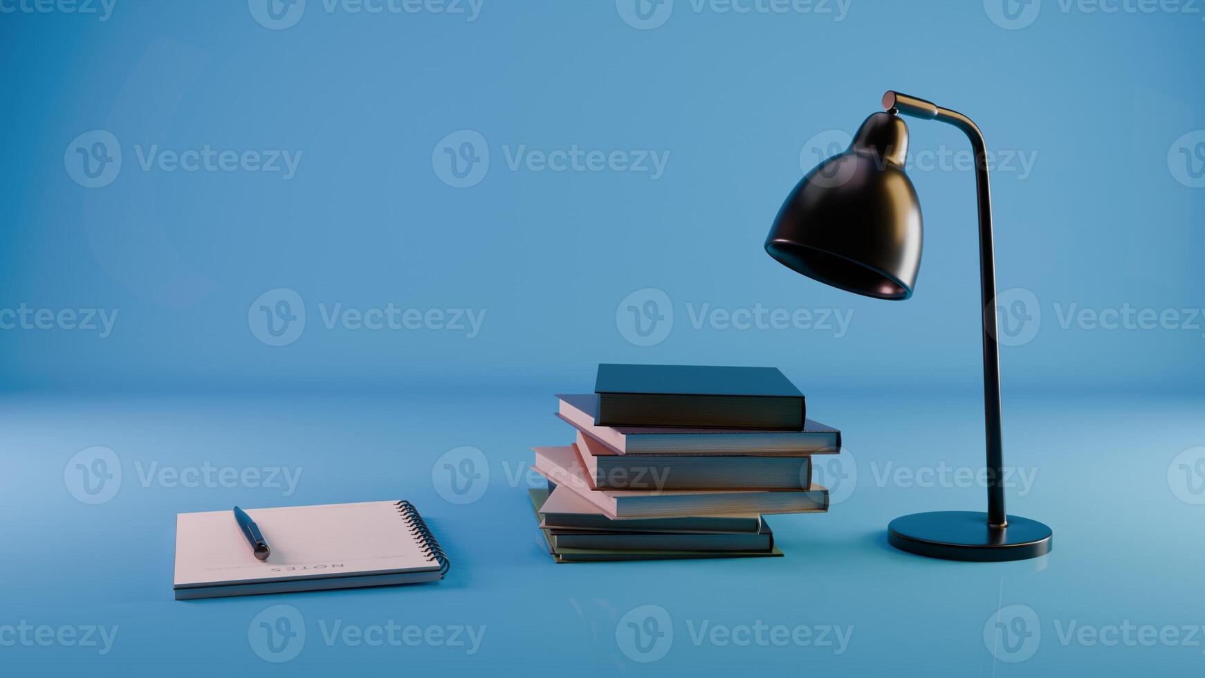 a desk lamp, notebook and stack of books on a blue background photo