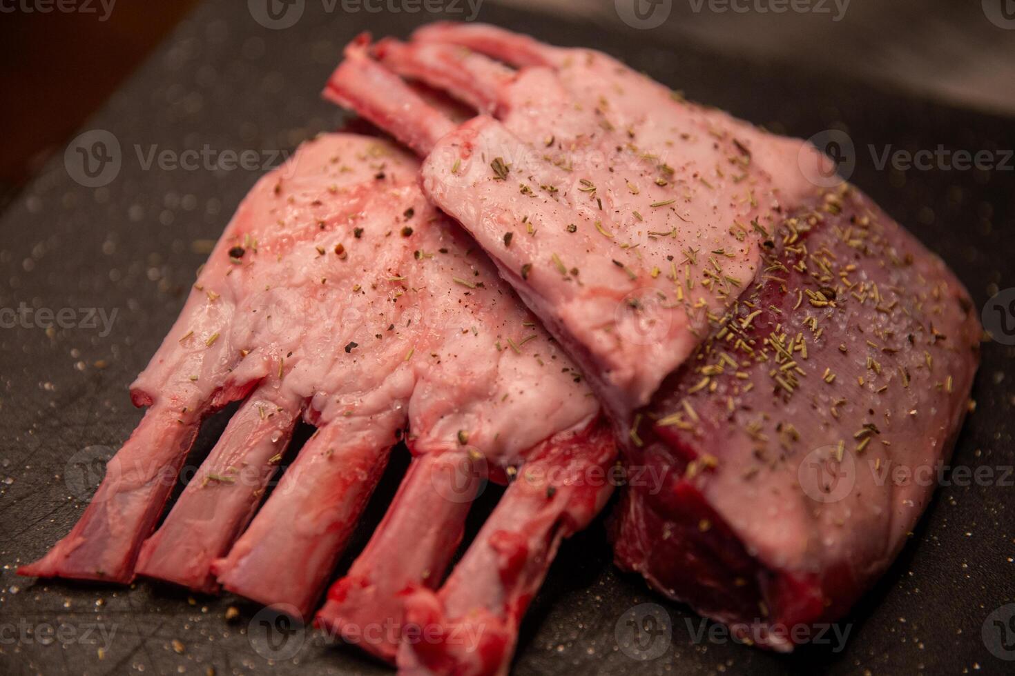 Two pieces of meat with spices on them photo