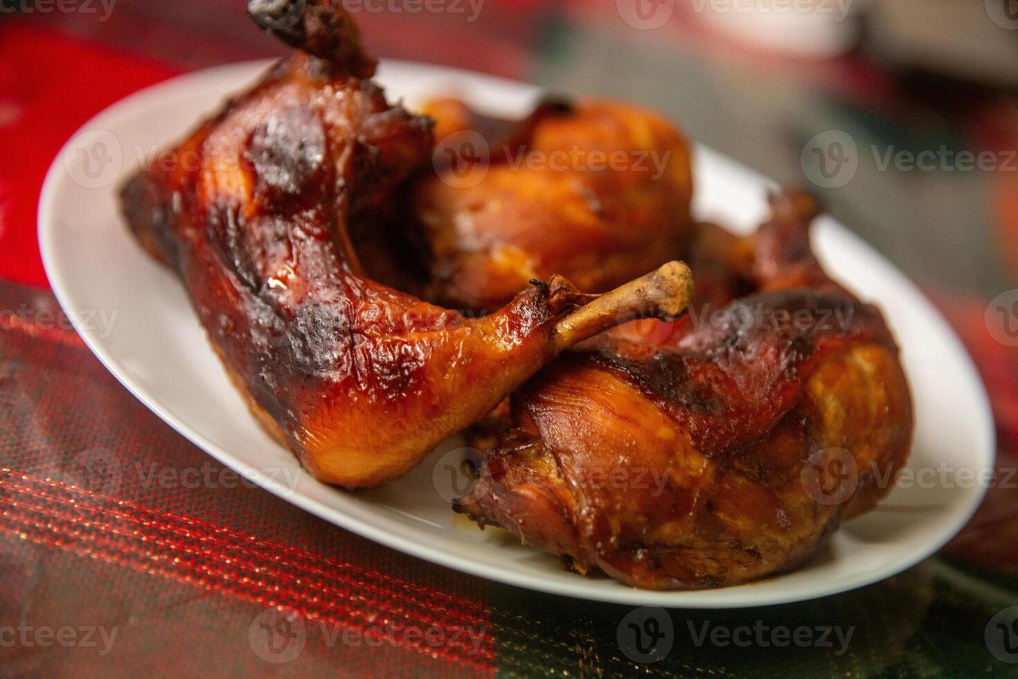 A plate of cooked chicken on a table photo