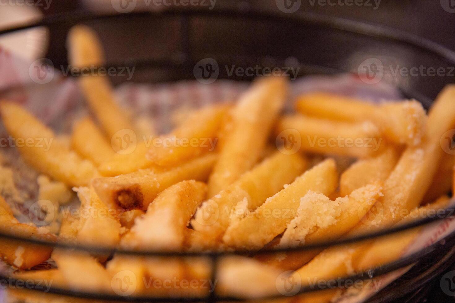 A basket of french fries sitting on a table photo