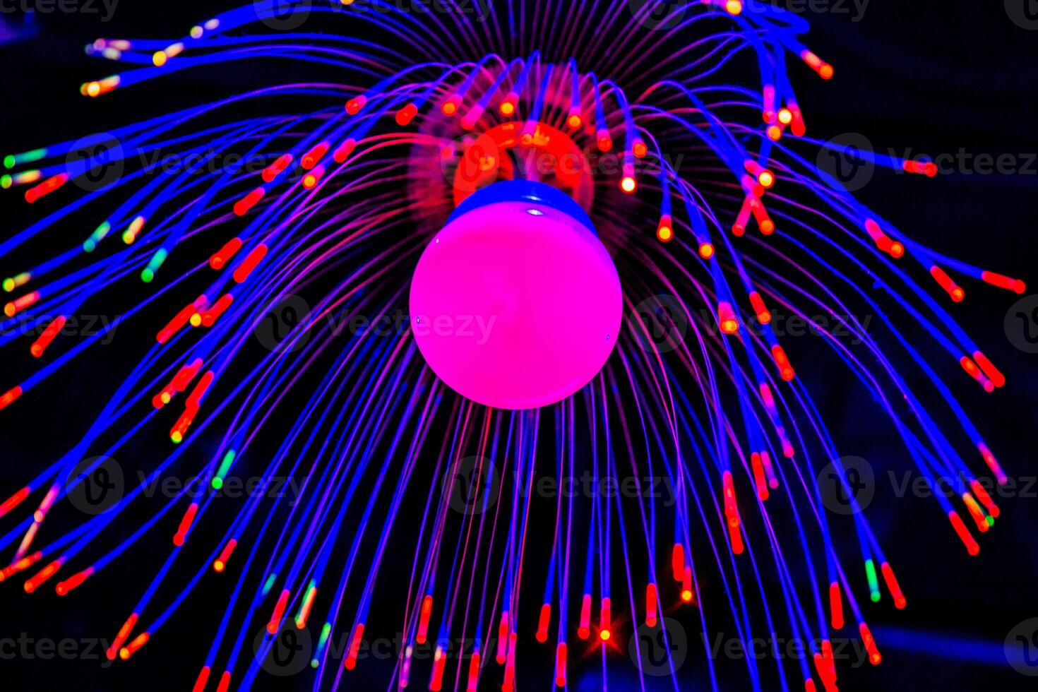 A colorful light bulb with a red and blue light photo