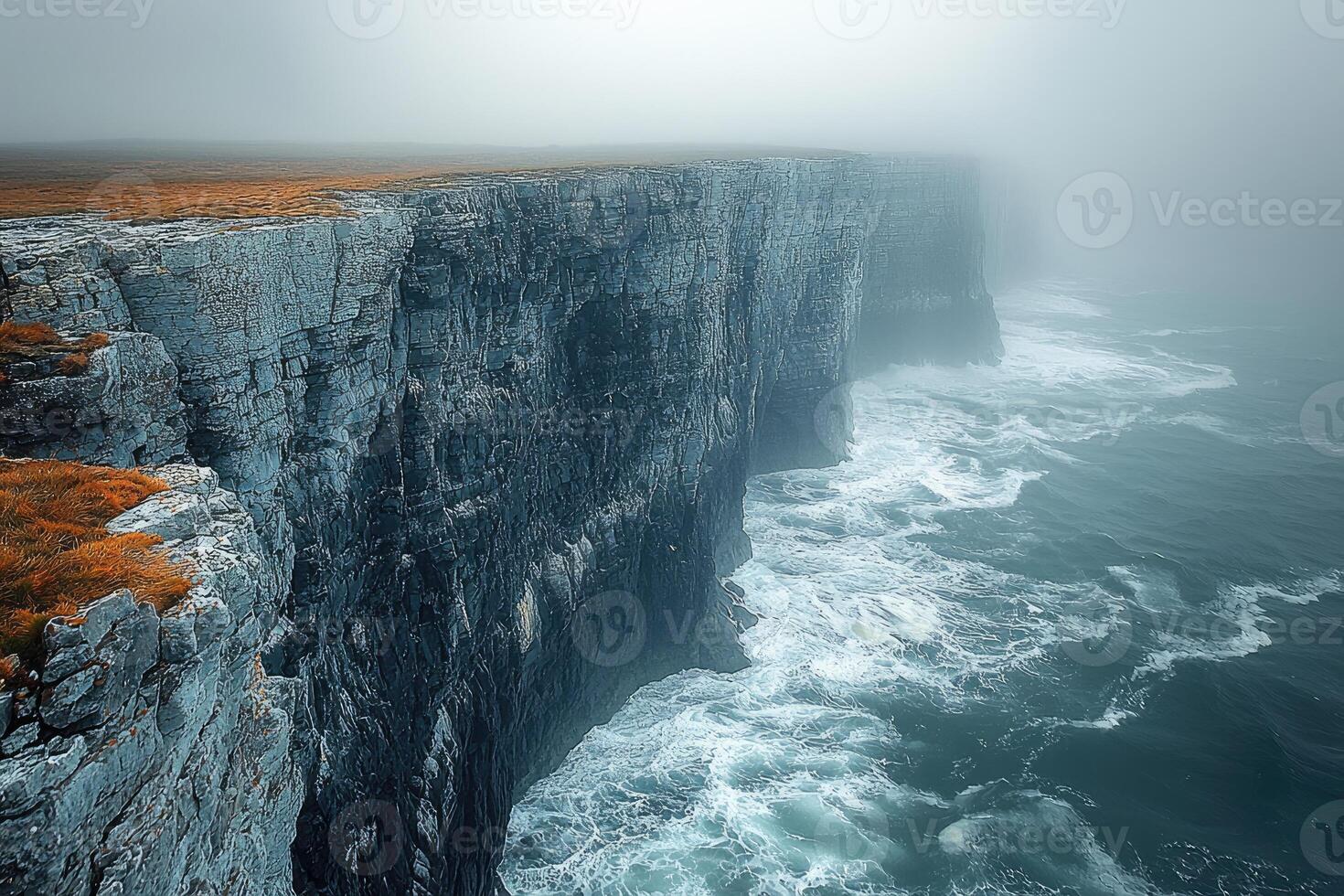 Dramatic Coastal Cliffs Enveloped In Misty Ocean photo
