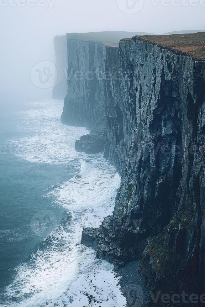 Dramatic Coastal Cliffs Under a Misty Sky photo