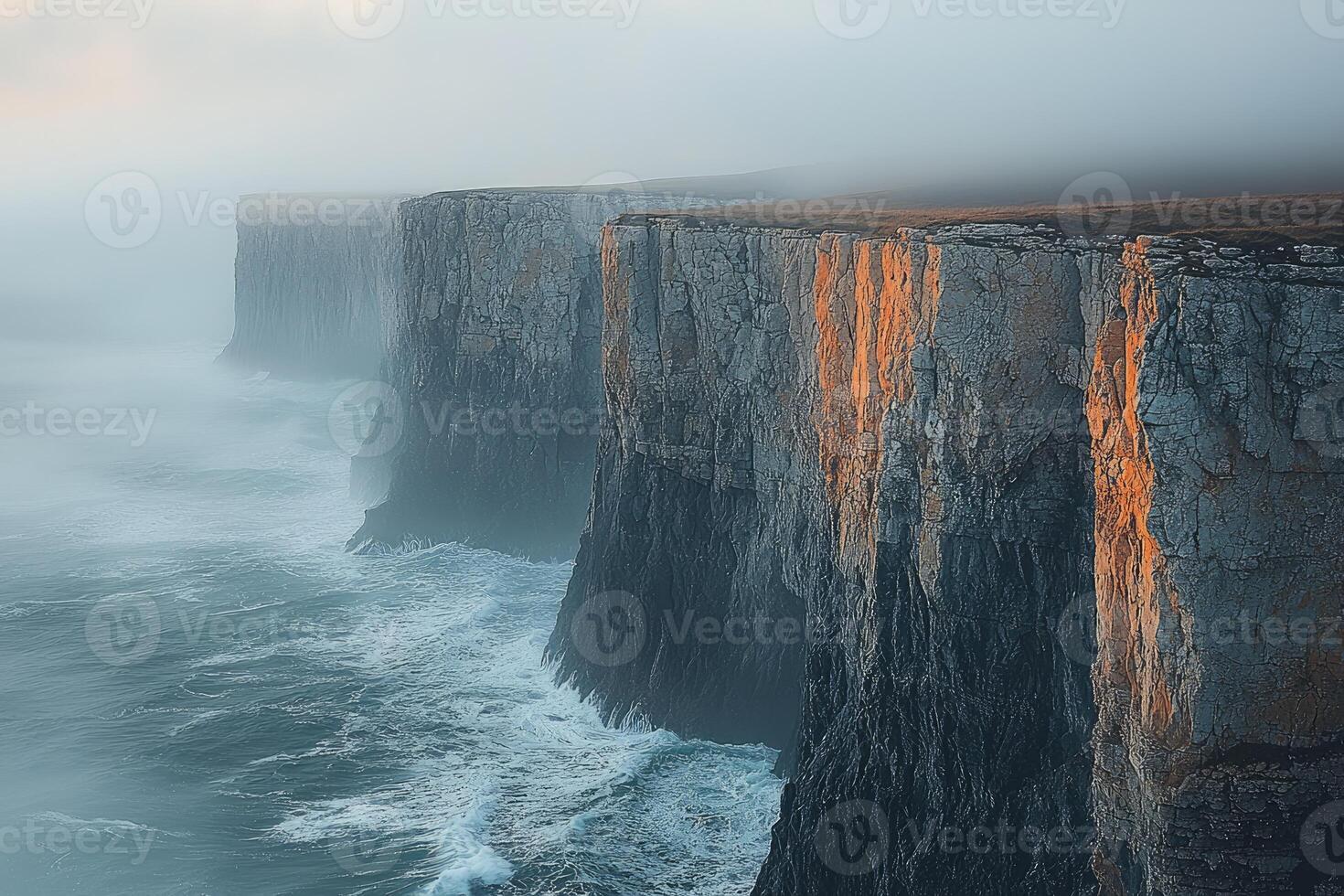 Majestic Cliffs and Ocean Waves in Misty Sunrise photo