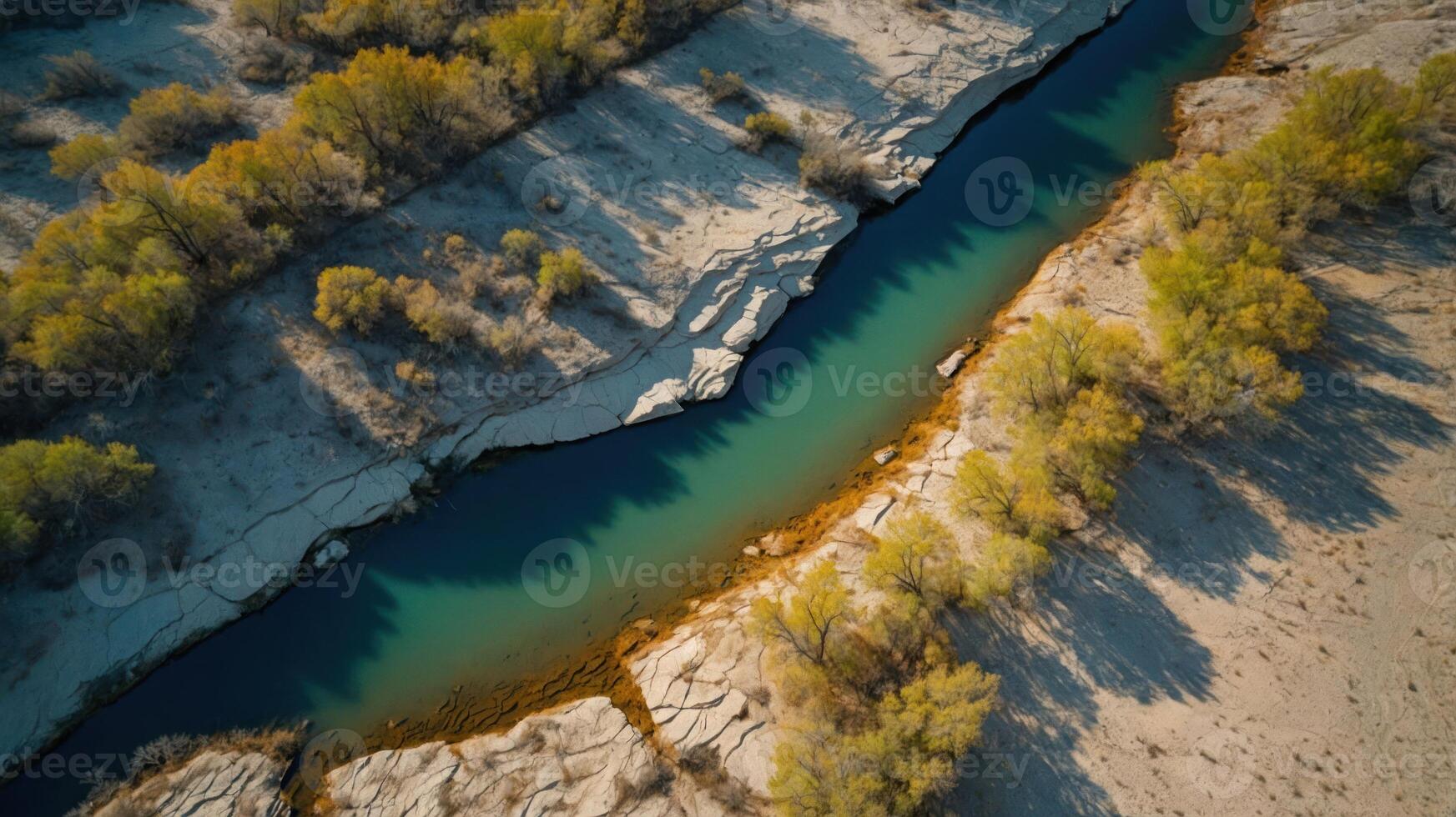 Aerial view of a winding river surrounded by sandy banks and trees in a natural landscape. photo