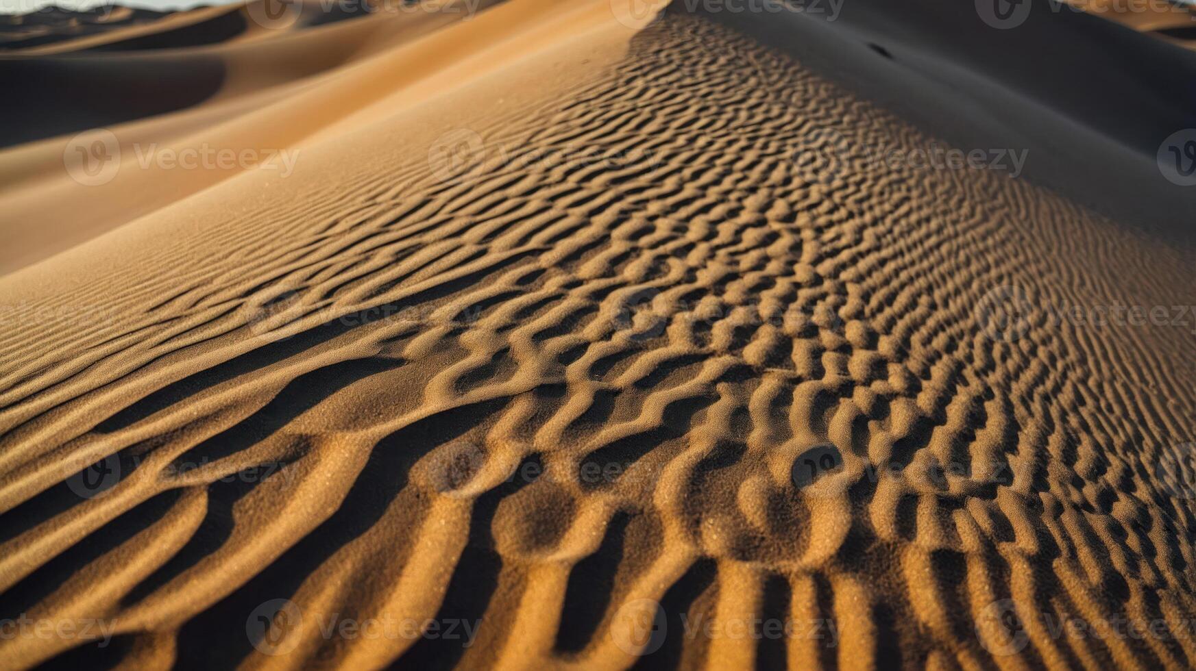 A close-up view of undulating sand dunes, showcasing natural patterns and textures. photo