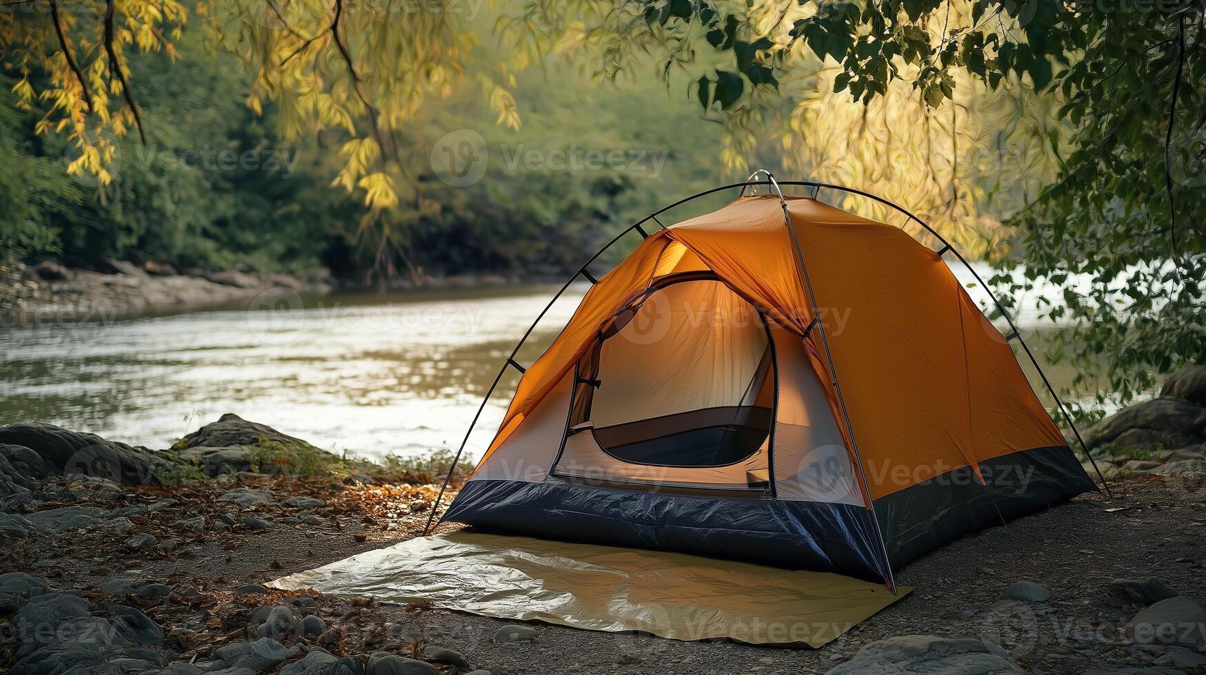 A secluded camping site by a river surrounded by autumn trees photo