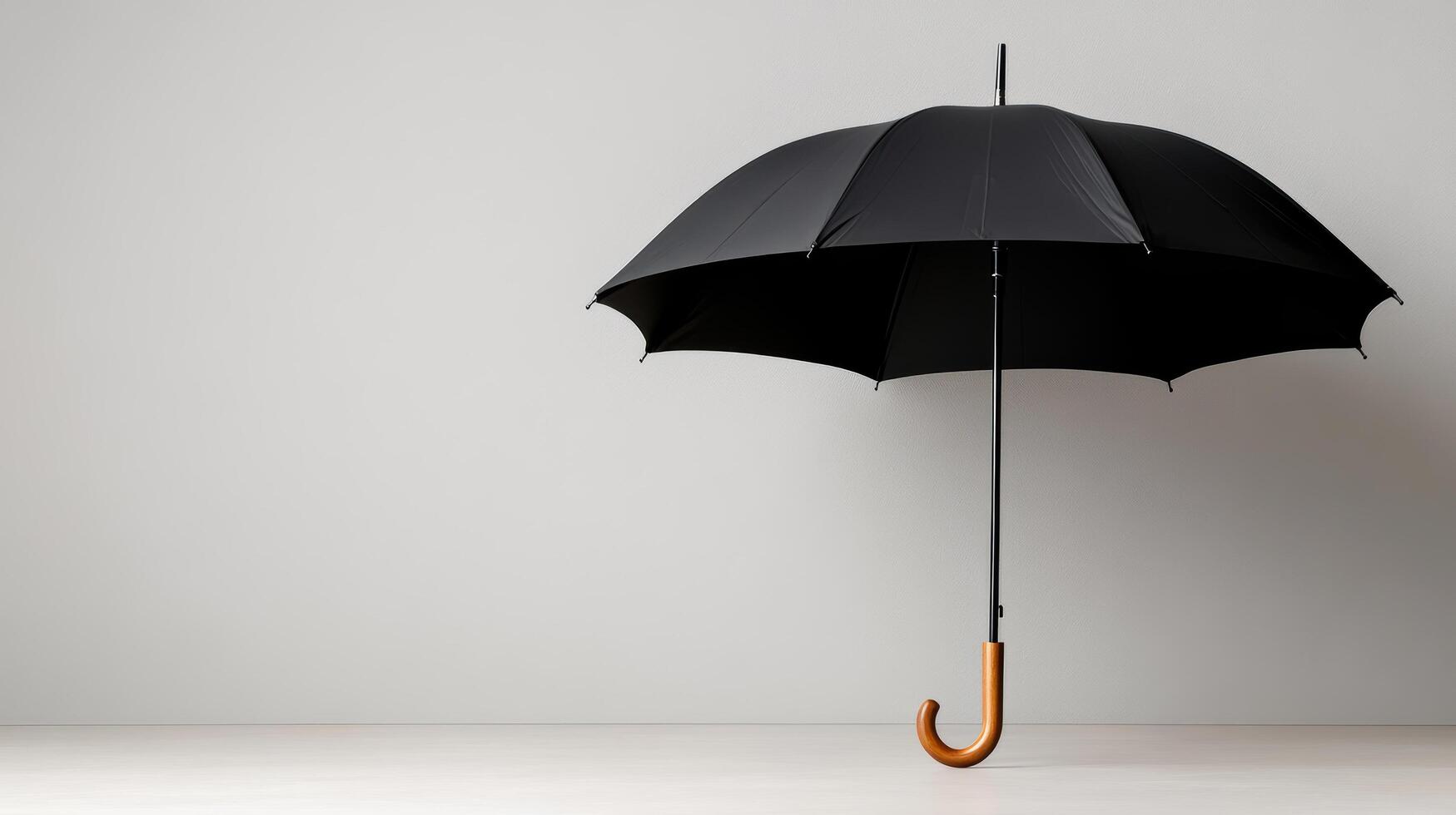 An open black umbrella on a white background photo