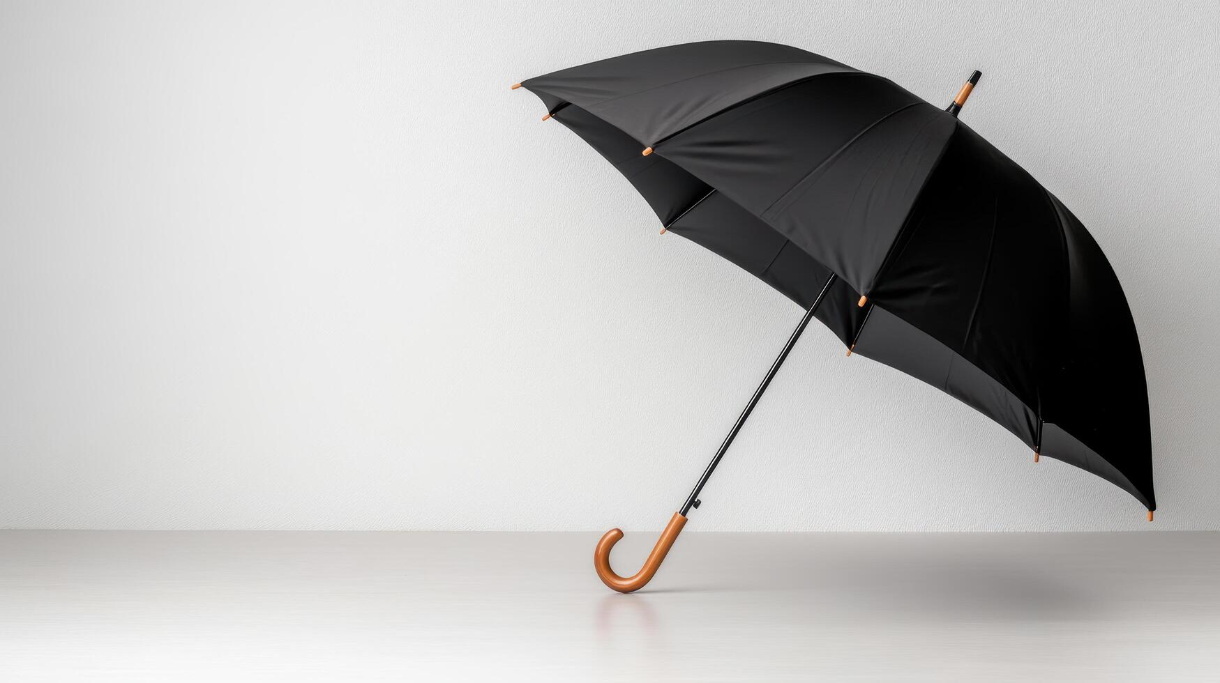 An open black umbrella on a white surface photo