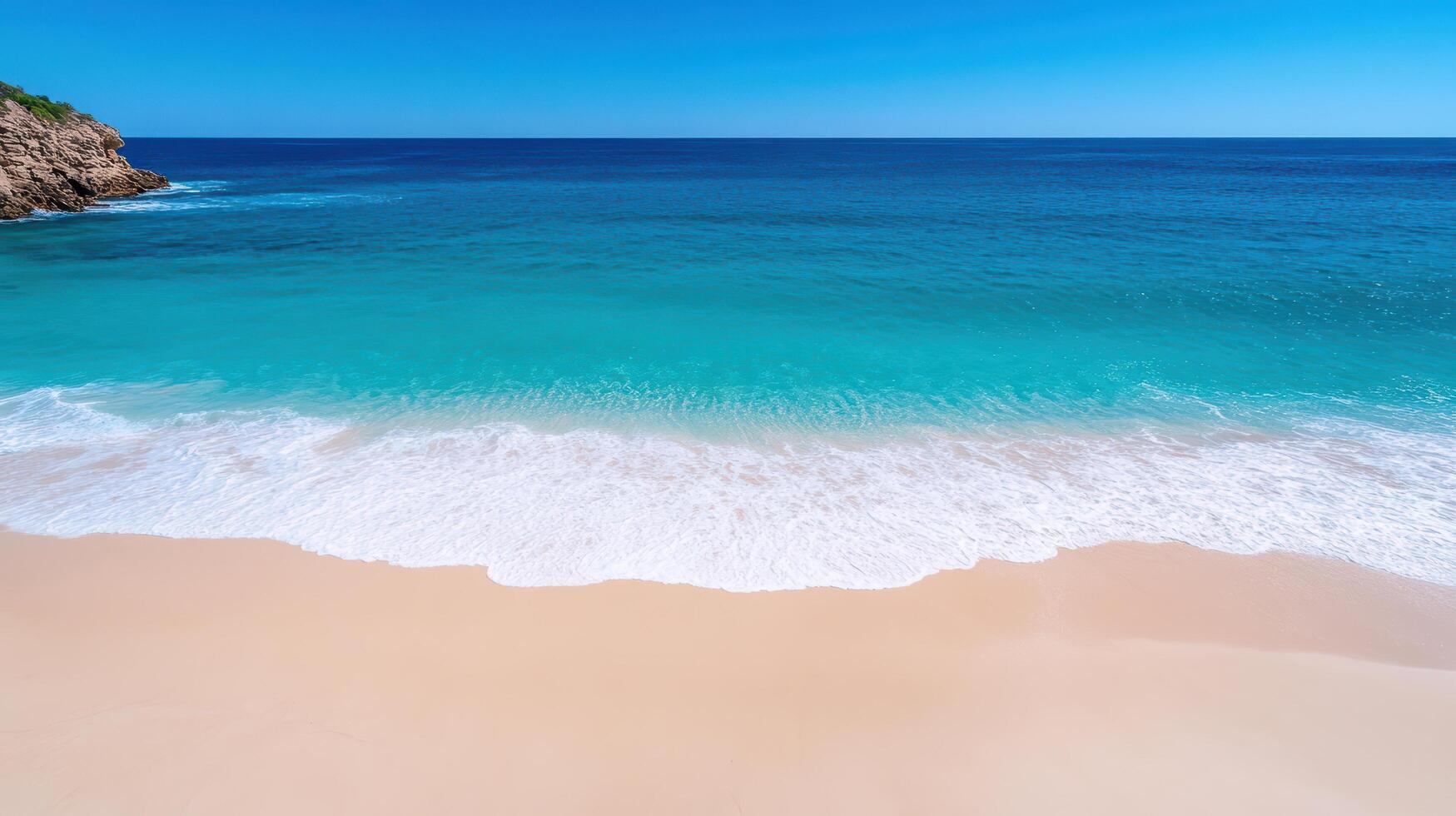 A beach with a clear blue sky and a sandy beach photo