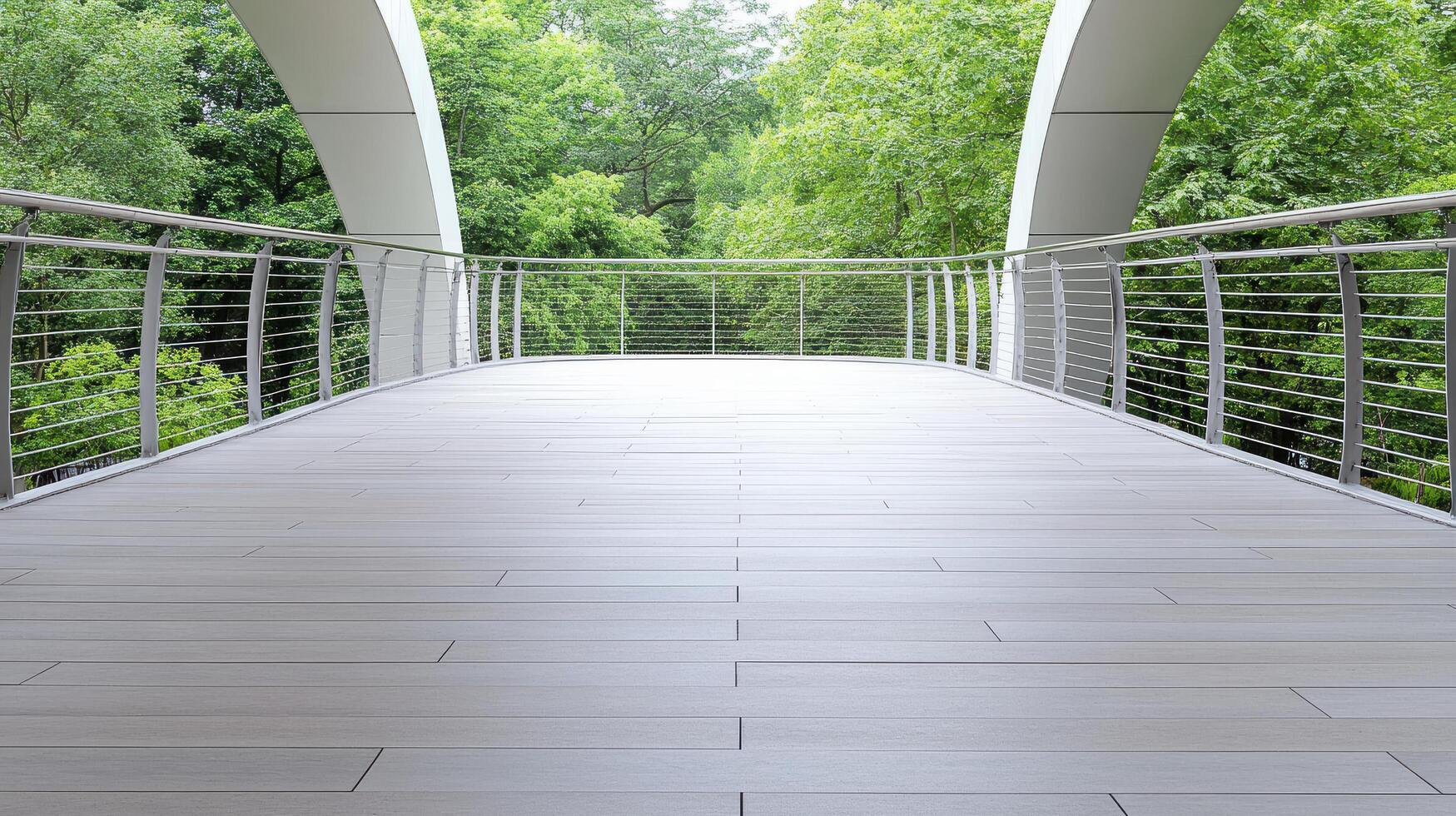 A bridge with a railing and a green forest in the background photo