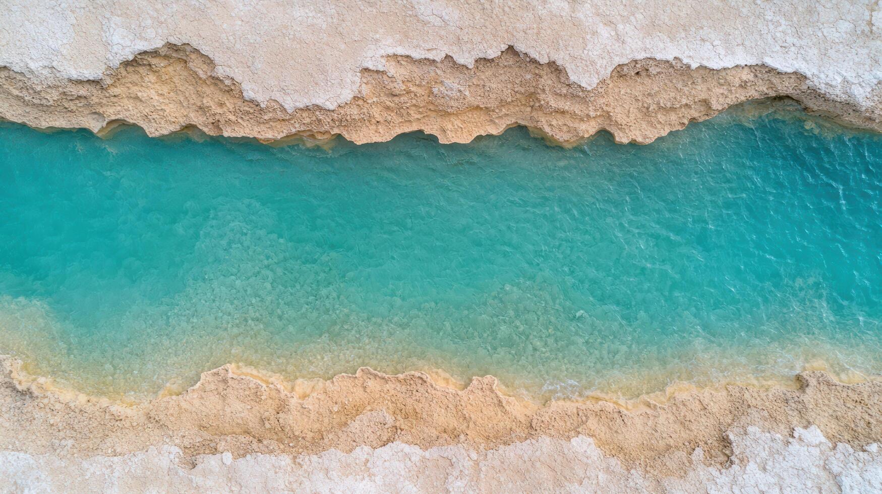 stunning aerial view of turquoise waterway surrounded by sandy terrain, evoking tranquility photo