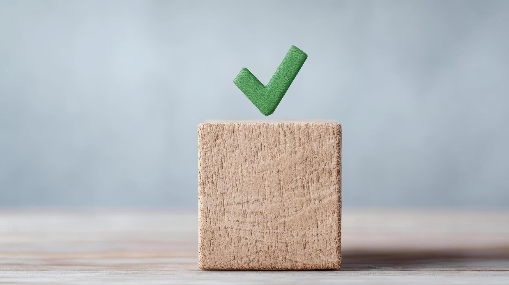 Wooden block with green check mark symbolizes approval and confirmation photo