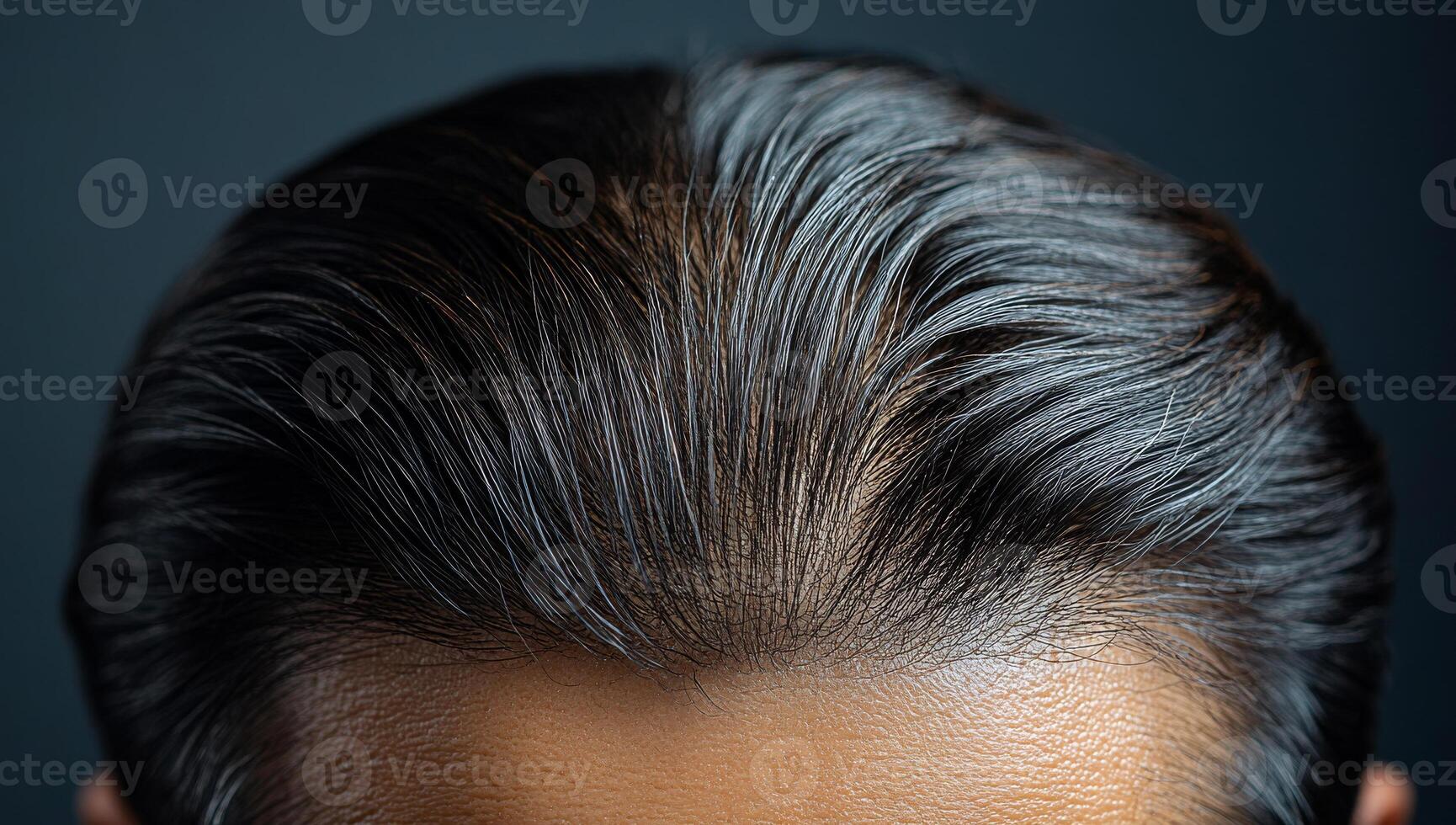 Close-up of a stylish haircut. Close-up view of a well-groomed hairstyle showcasing smooth and shiny black hair on a person's head. photo