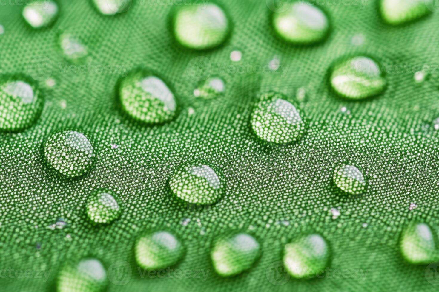 Close-up of textured green outerwear fabric showcases rain droplets, emphasizing durability and outdoor readiness for adventure photo