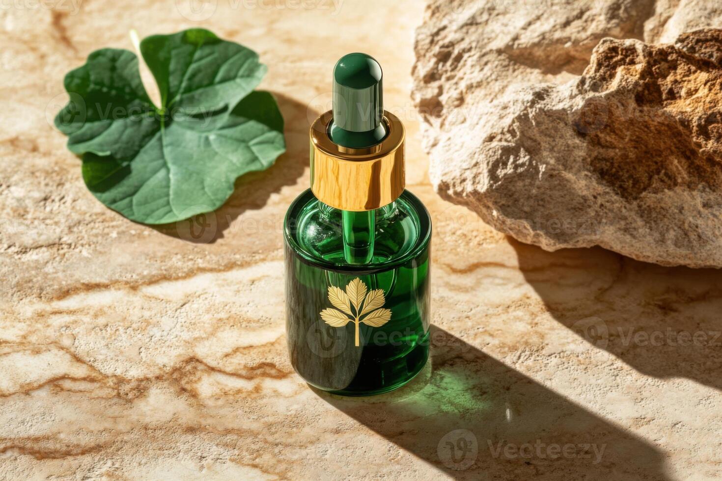Green cosmetic serum bottle with gold elements standing on marble surface with leaf and stone photo