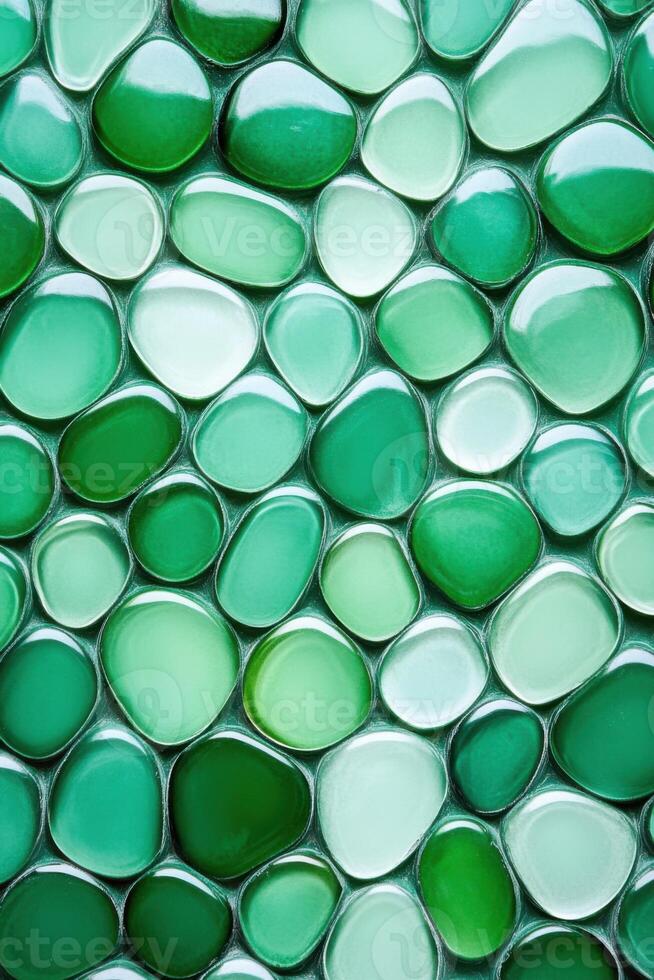 Green textured background showing glossy irregular pebble tiles photo