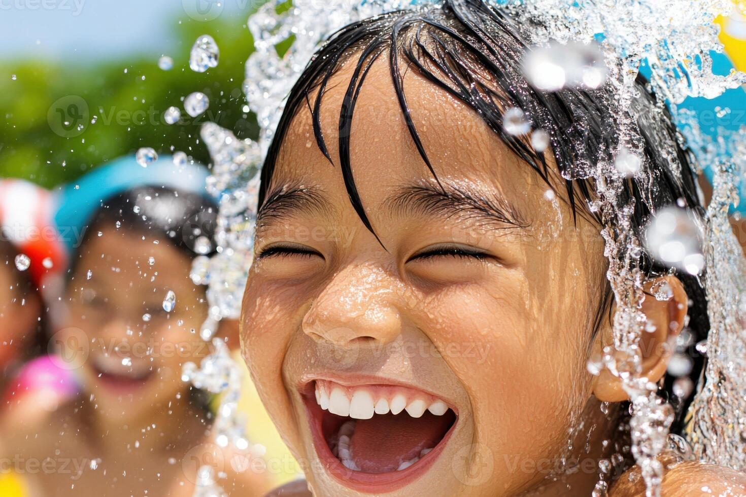Happy child laughing and playing with water splashes in summer photo