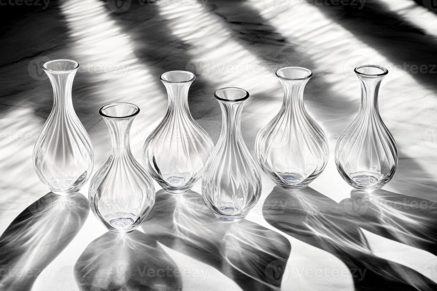 Ribbed glass vases casting shadows on white surface photo