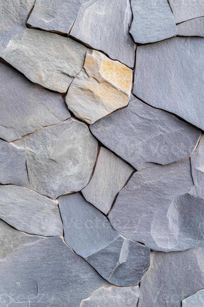Grey slate rock wall forming a decorative pattern with subtle shadow photo