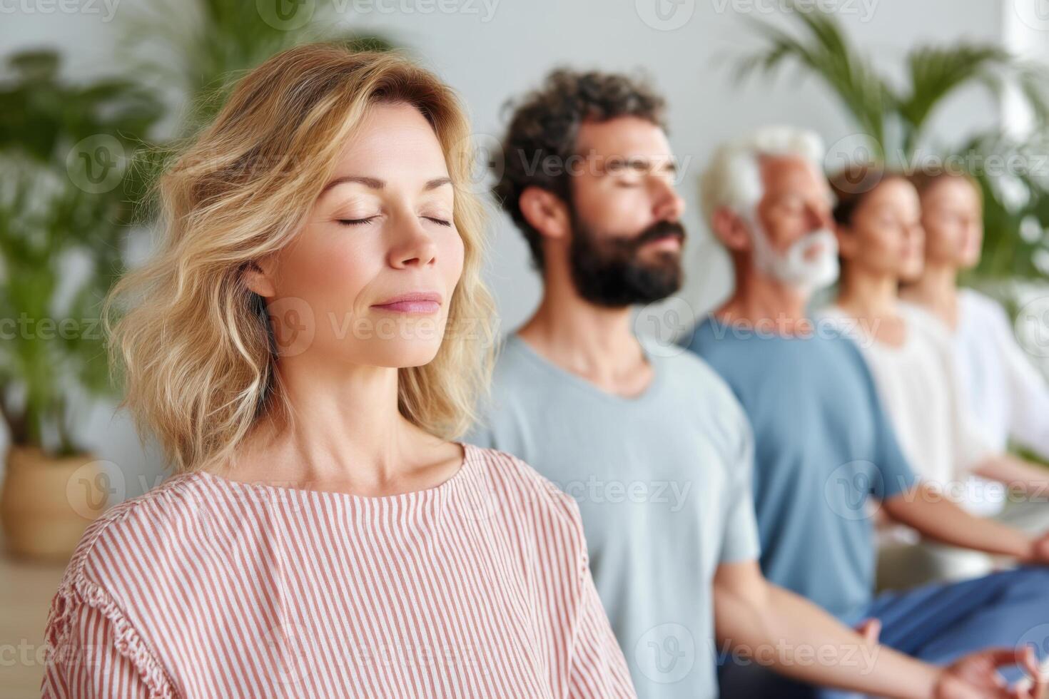 Group of people practicing mindful breathing exercises during yoga class photo