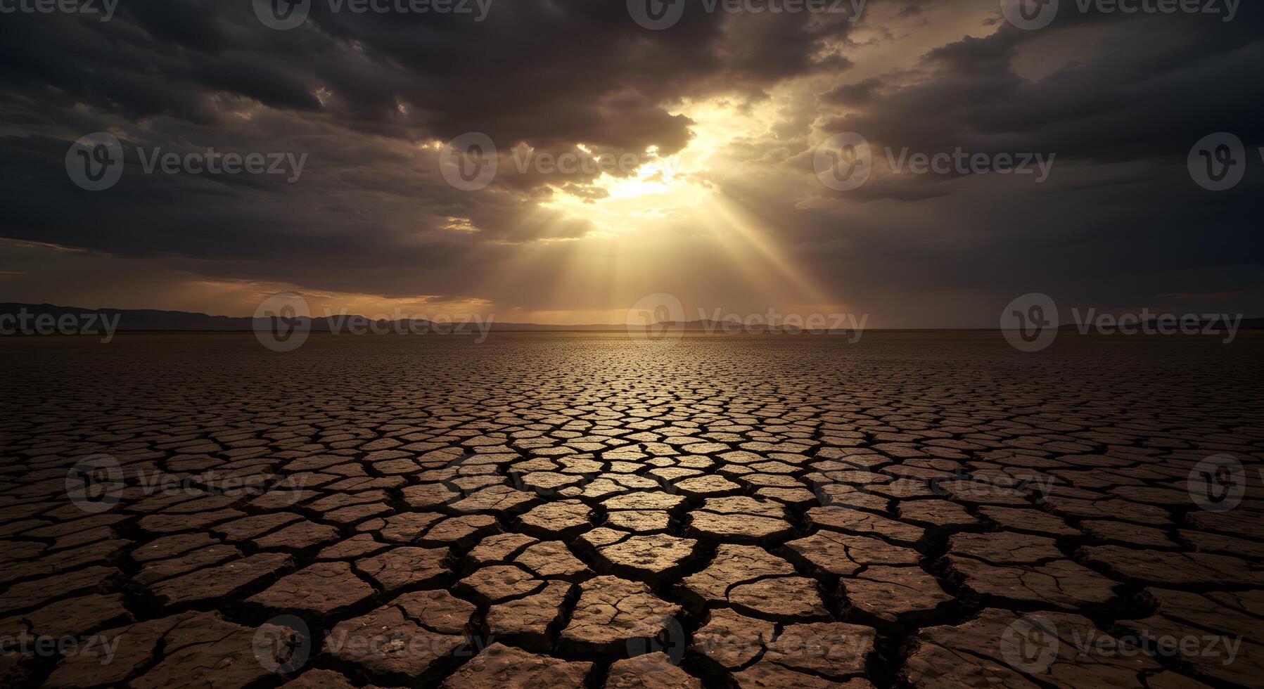 Dramatic Sunlight over Cracked Earth, A Stark Depiction of Environmental Challenges photo