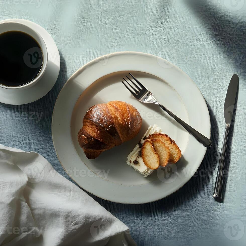 close up of croissant and cup of coffee. Breakfast with croissant, coffee and cheese on the table. Top view. flat lay, selective focus. photo