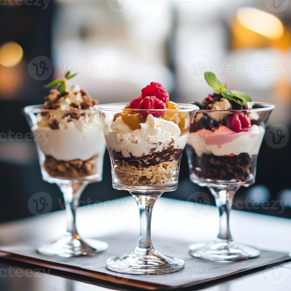 whipped cream dessert with berries in glasses on a table in a cafe. close up, selective focus. photo