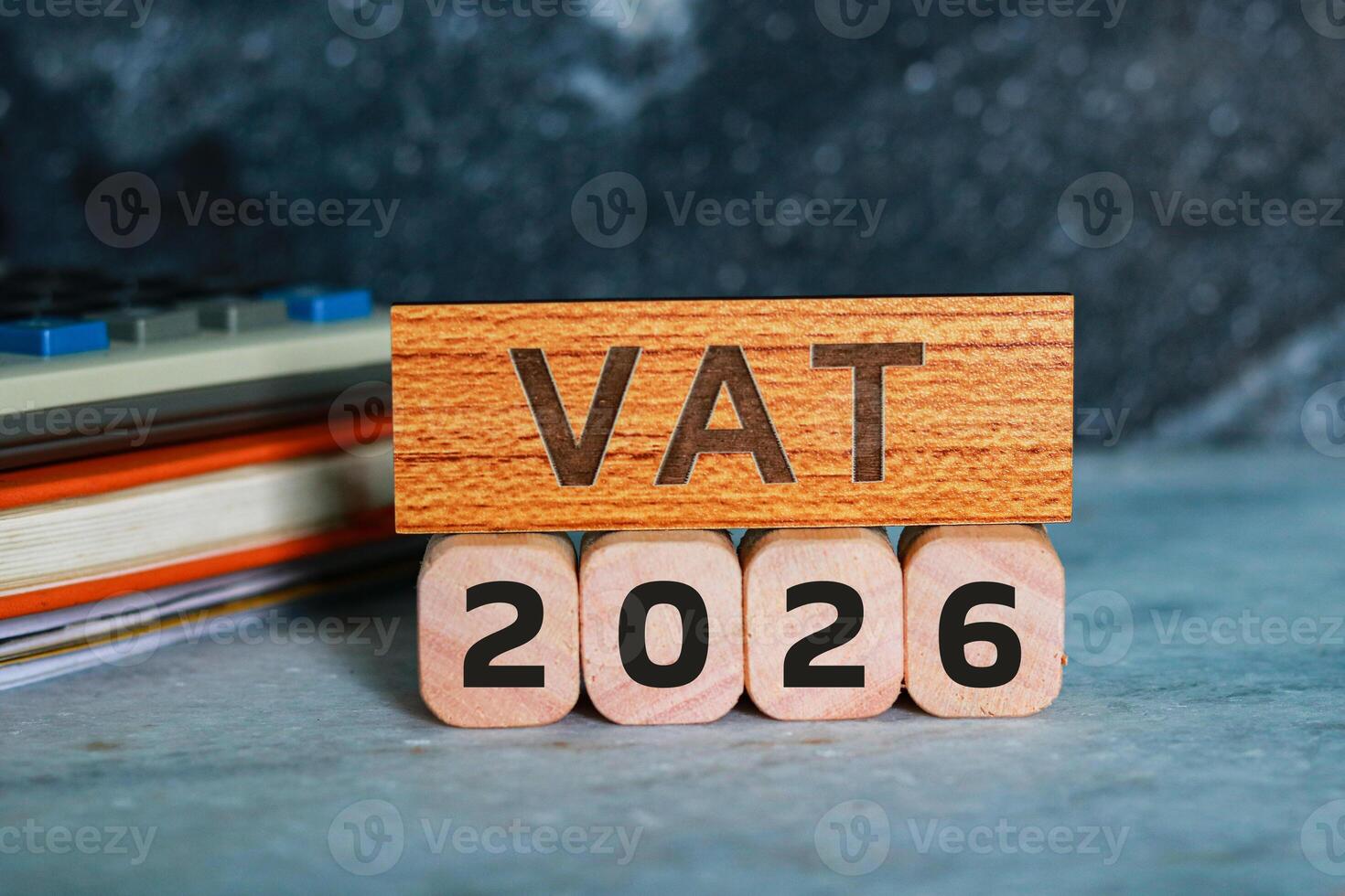 VAT 2026 on wooden cubes with calculator and notepad. photo
