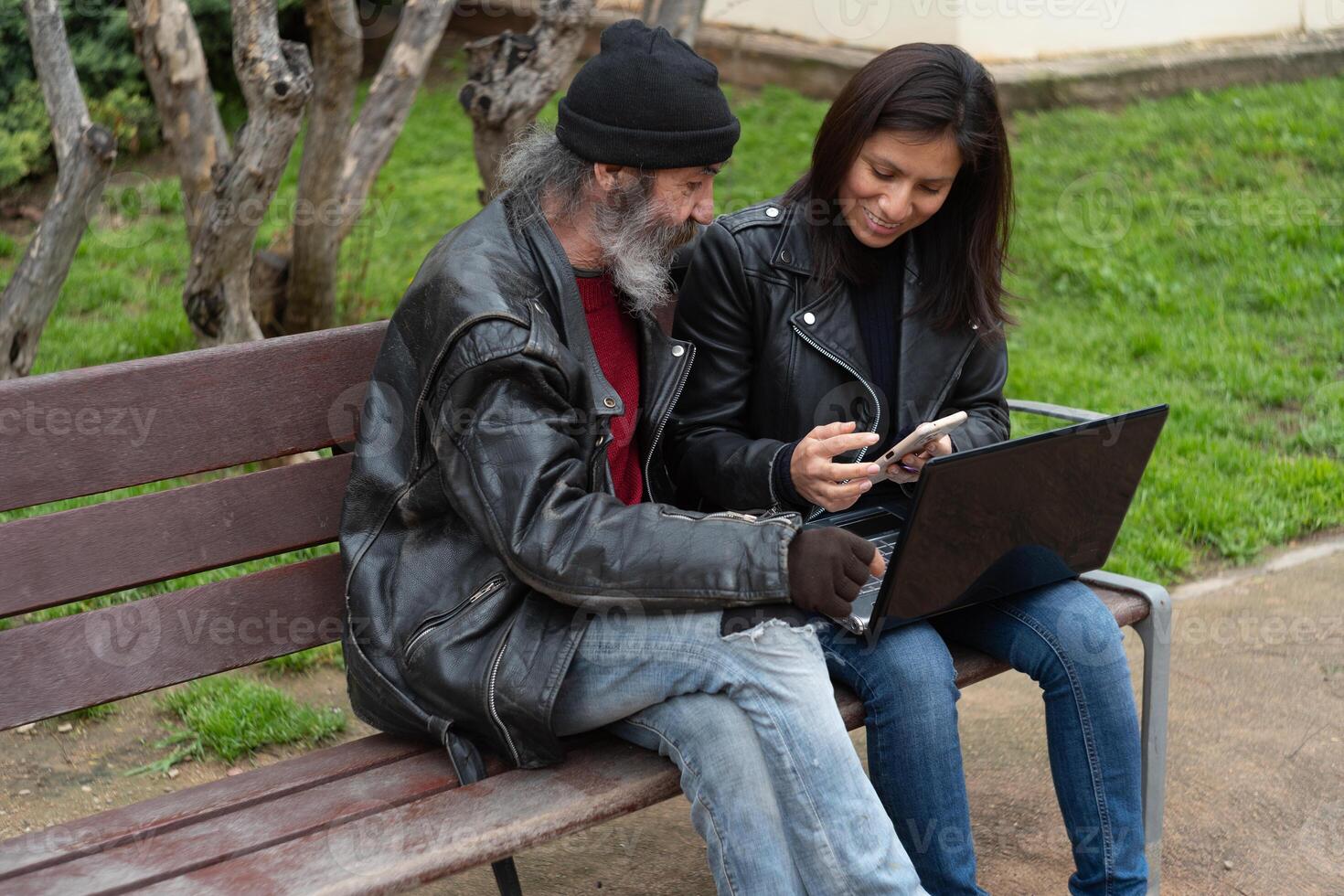 An older man paying attention to a young woman who is showing him different activities that can be done on the Internet. photo