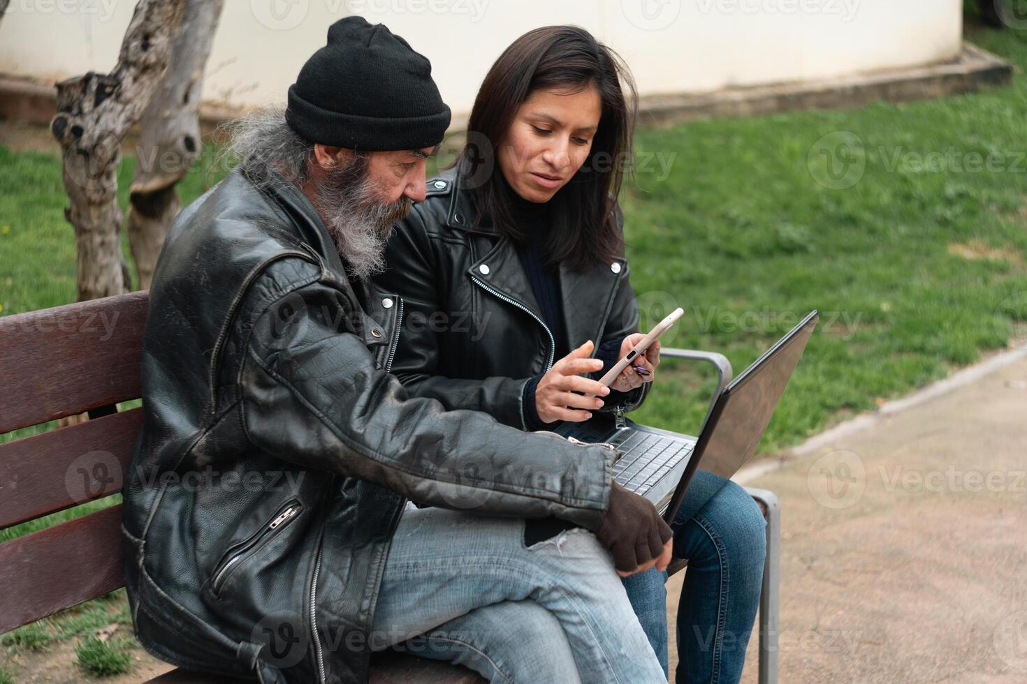 Exchange of views between an older man and a young woman with a laptop. photo