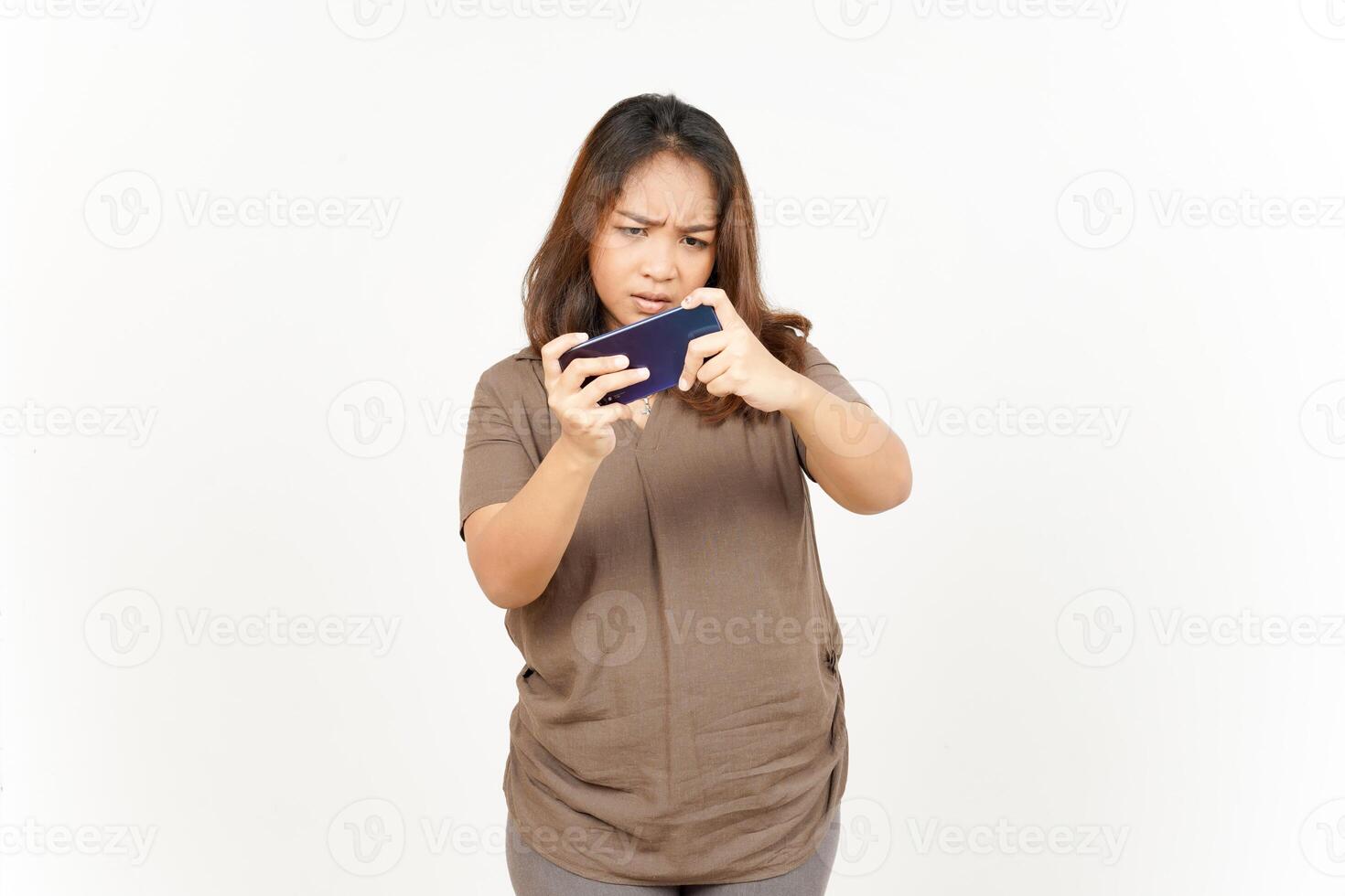 A woman holding a cell phone and looking at it photo