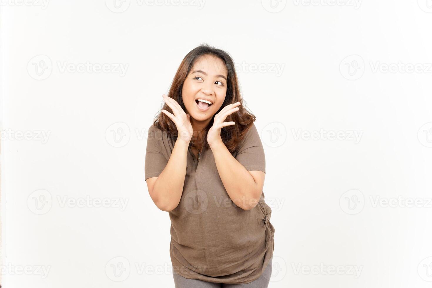A woman is making a face while standing on a white background photo