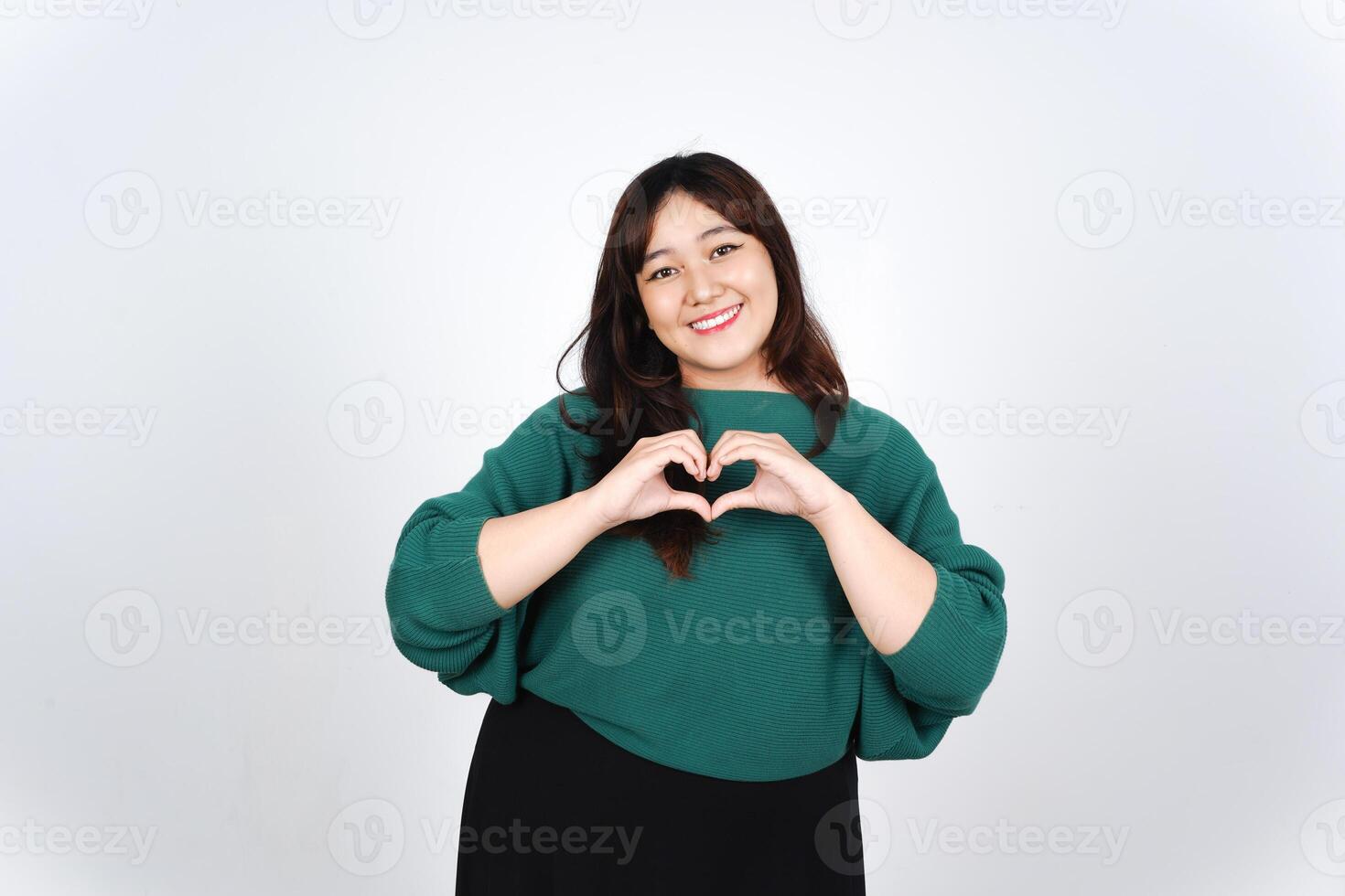 Asian woman making heart shape with hands photo