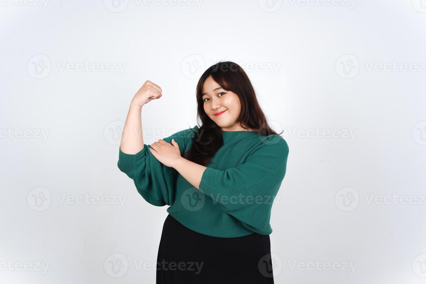 Asian woman flexing her arm in front of white background photo
