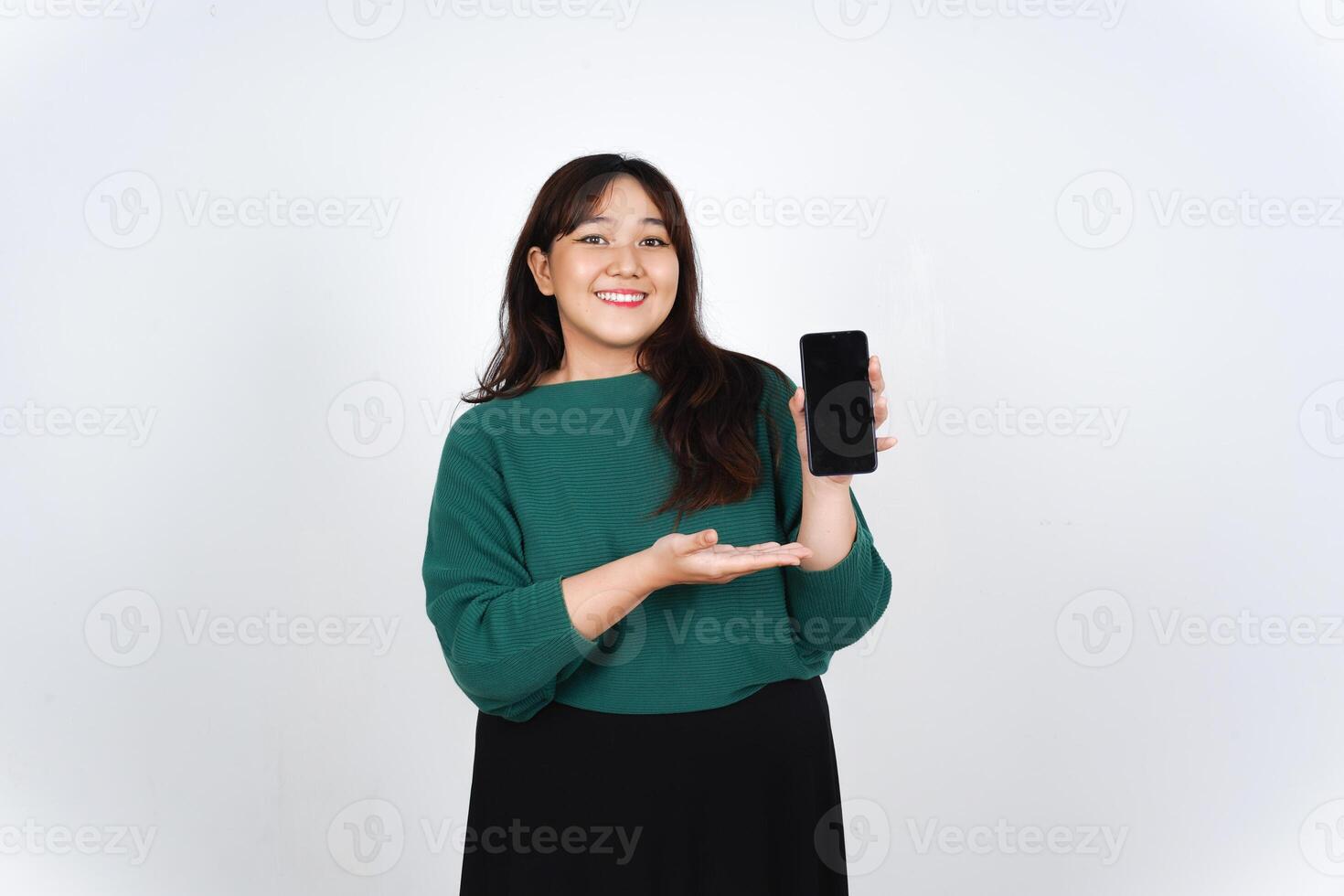 A woman holding a cell phone in her hand photo