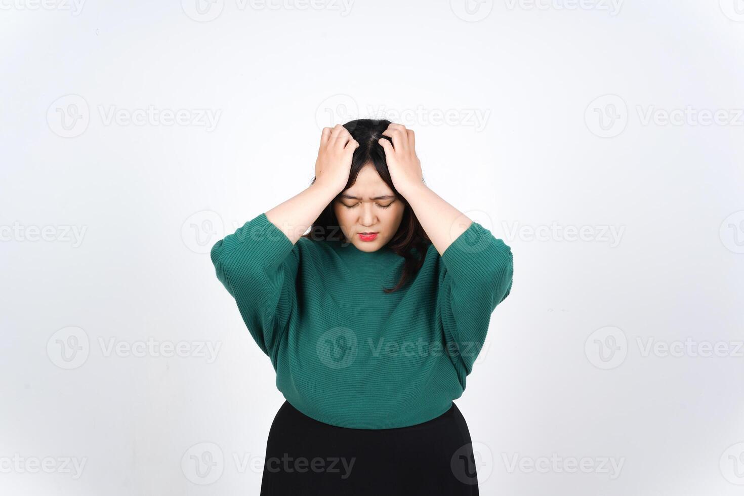 A woman in a green shirt and black skirt photo