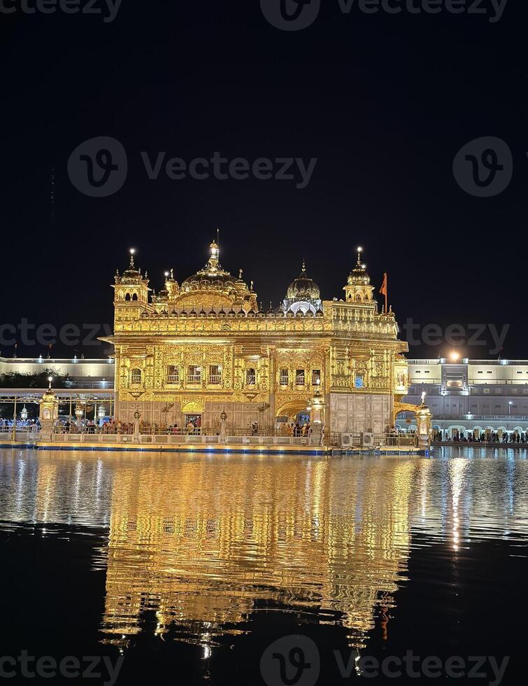 Golden Temple at night reflected in Amrit Sarovar, Amritsar, India. photo