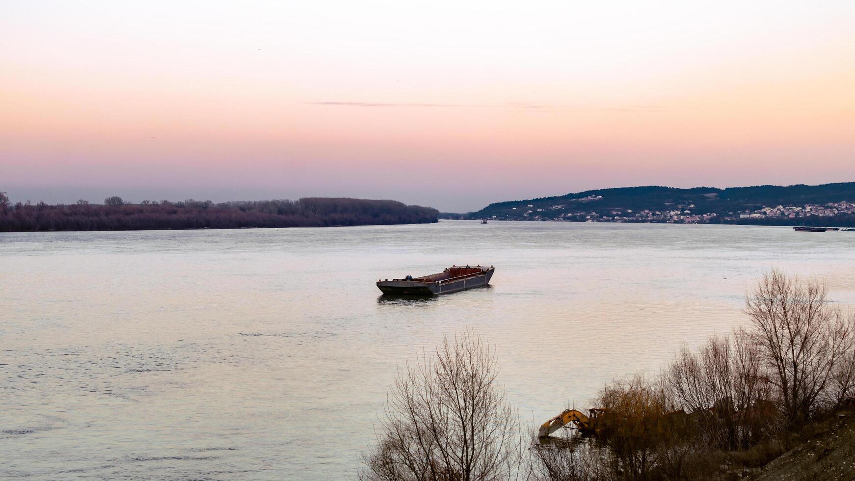 Tranquil Cargo Barge on the Danube at Dusk photo