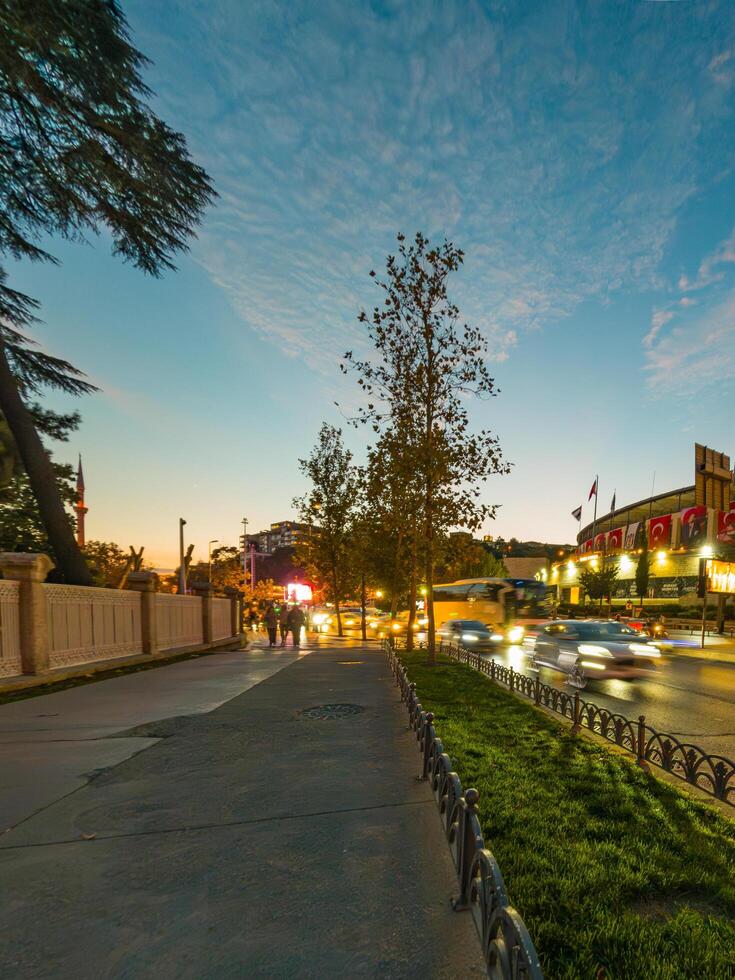 Vibrant City Street at Dusk with Blurred Traffic Lights photo