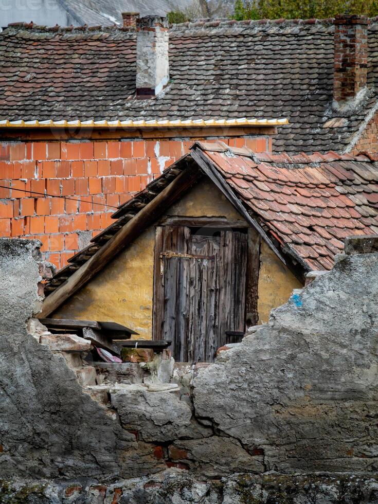 Timeworn Attic and Crumbling Walls of a Forgotten Home photo
