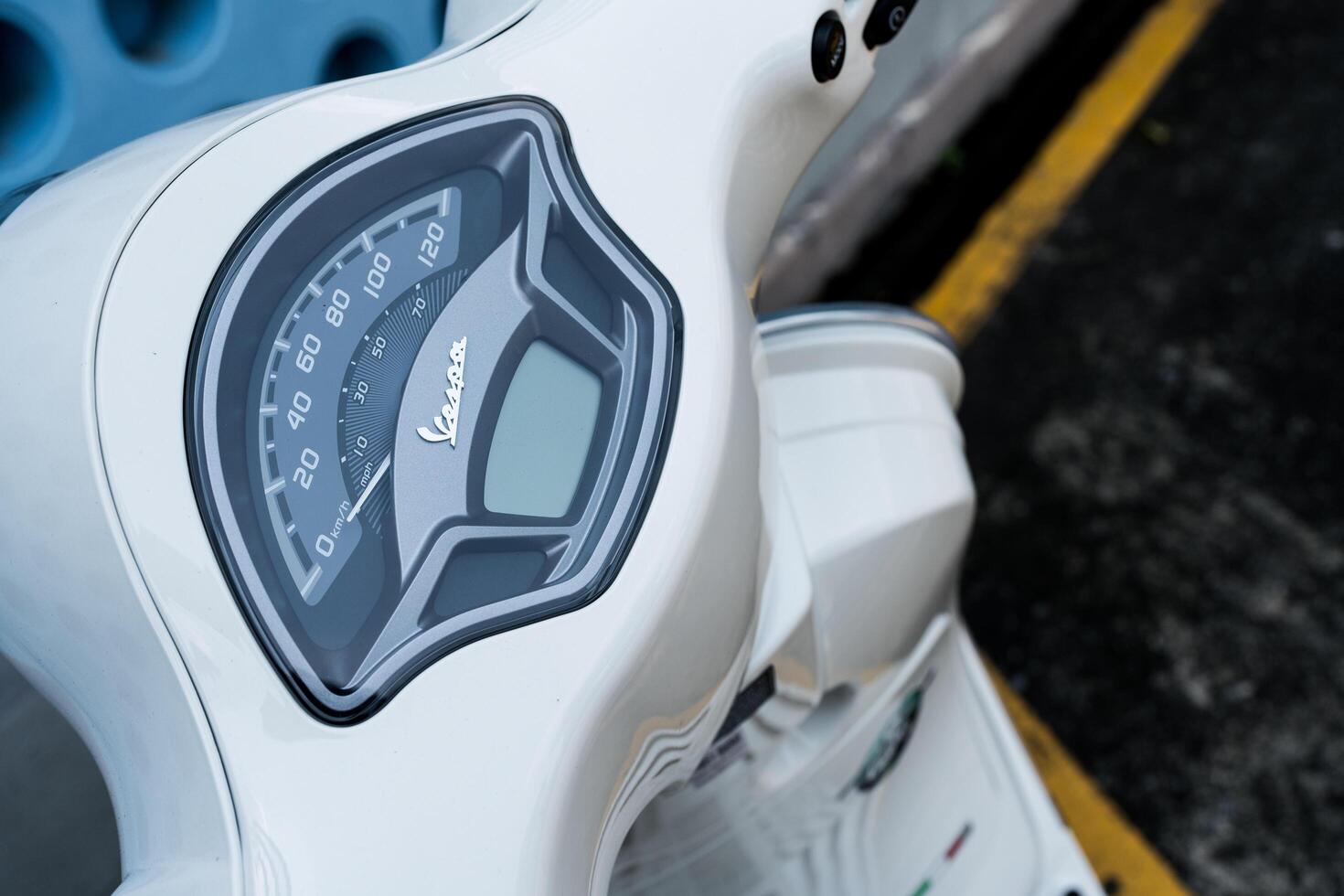 Bangkok, Thailand - March 27, 2025 Dashboard is on a white vespa LX 125 for shows the speed and amount of gasoline in the tank. photo